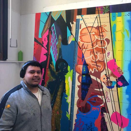 Student in front of their artwork.