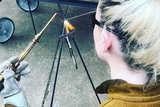 Sculpture student welding