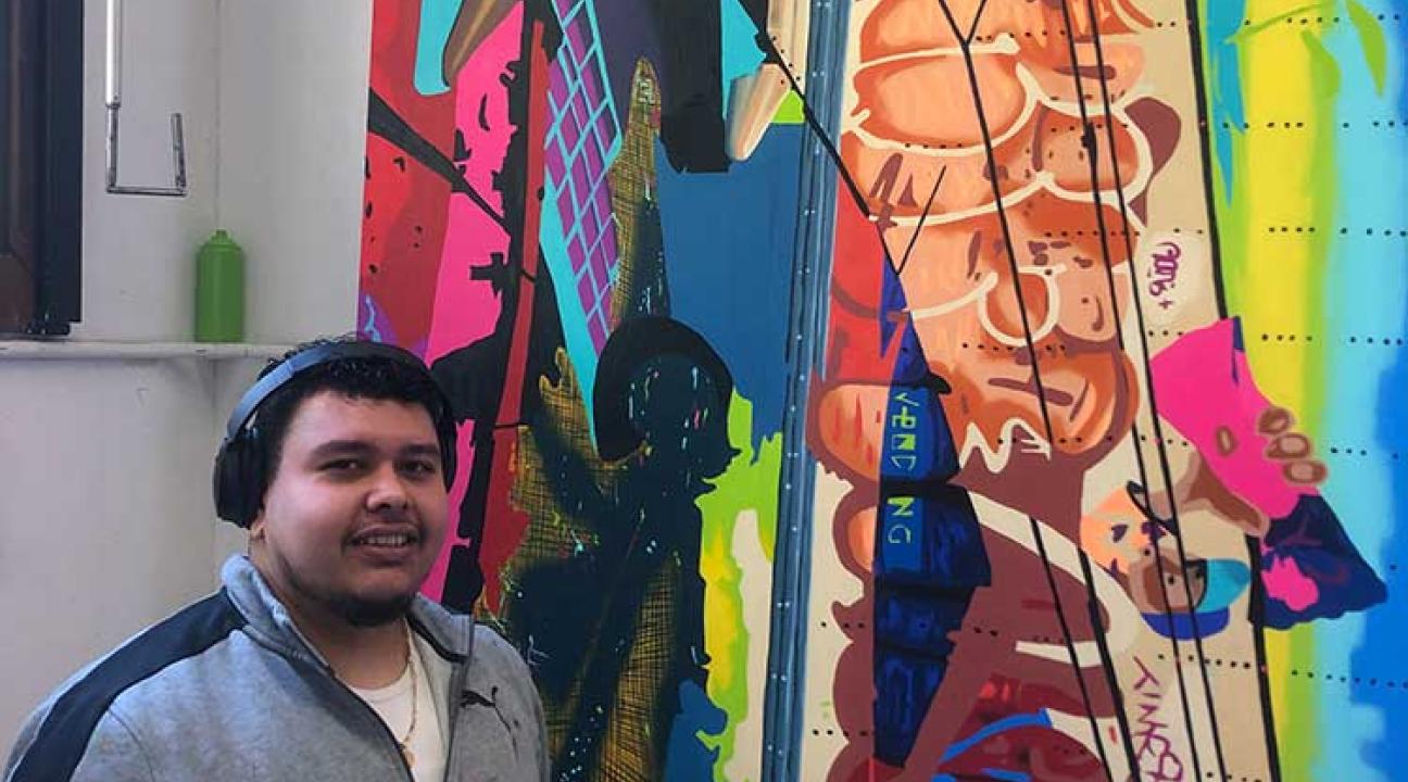 Student in front of their artwork.