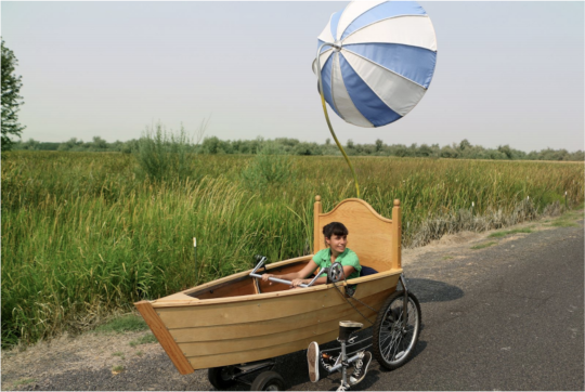 Sena Clara Creston riding in her "Umbrella Ship"